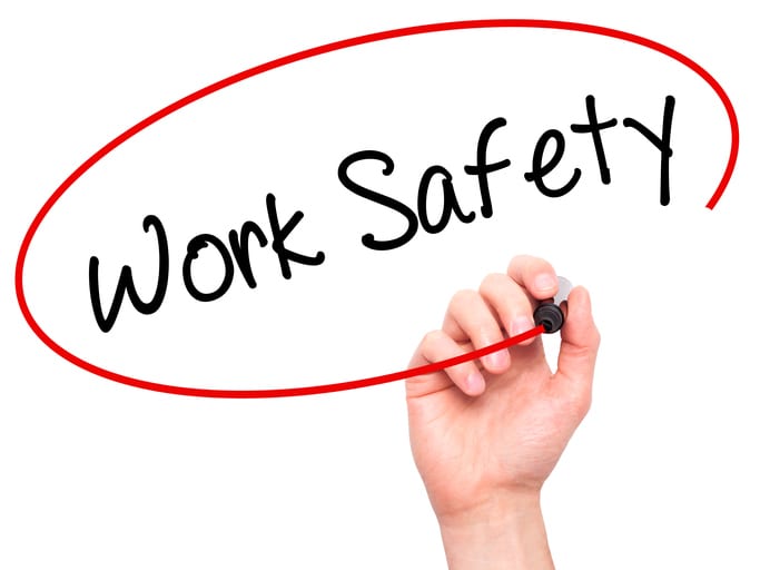 Palmetto Electrical Contractors | hand with a marker writing Work Safety in a red circle